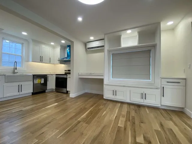 a kitchen with appliances cabinets and a sink