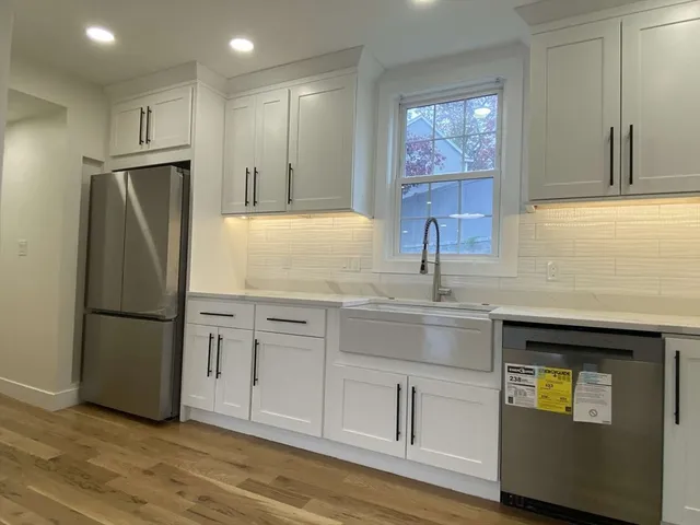 a kitchen with kitchen island granite countertop a stove and a sink