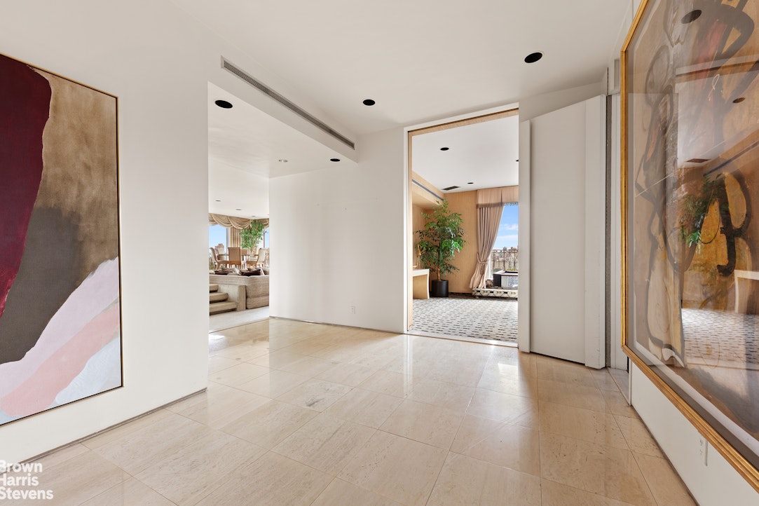 101 Central Park West, Unit PHF Manhattan, NY 10023 - Photo 24 of 27 a view of a hallway with wooden floor and a living room