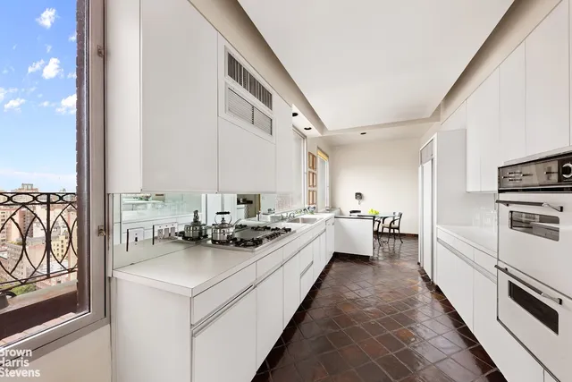 a view of a hallway with stairs and furniture