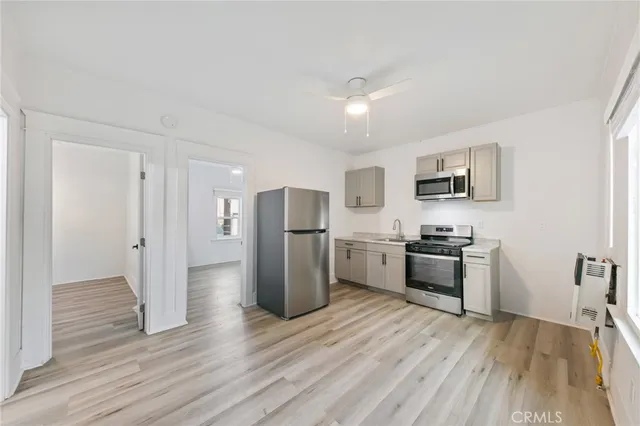 a kitchen with stainless steel appliances a refrigerator stove microwave and cabinets