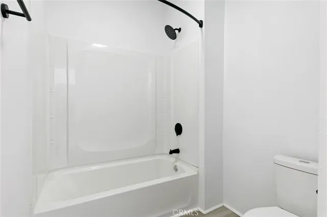 a bathroom with a bathtub and a toilet