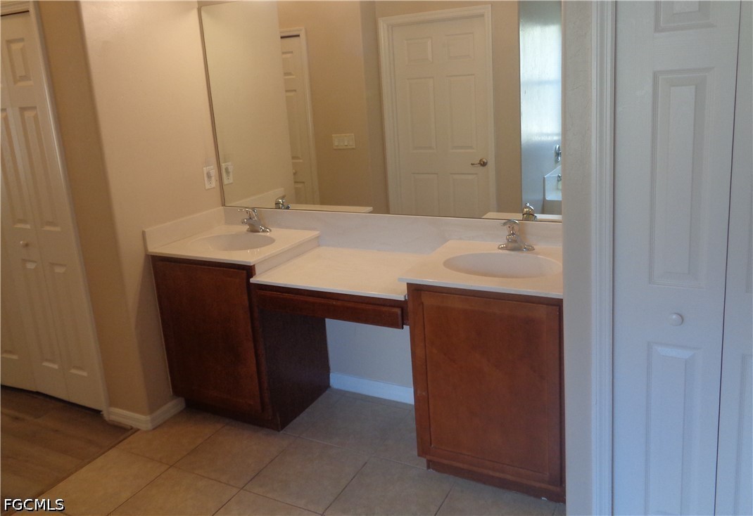 2463 Nature Pointe Loop Fort Myers, FL 33905 - Photo 29 of 50 a bathroom with a double vanity sink and a mirror