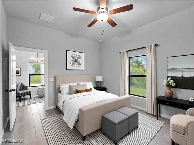 a bedroom with a large bed couch and a window