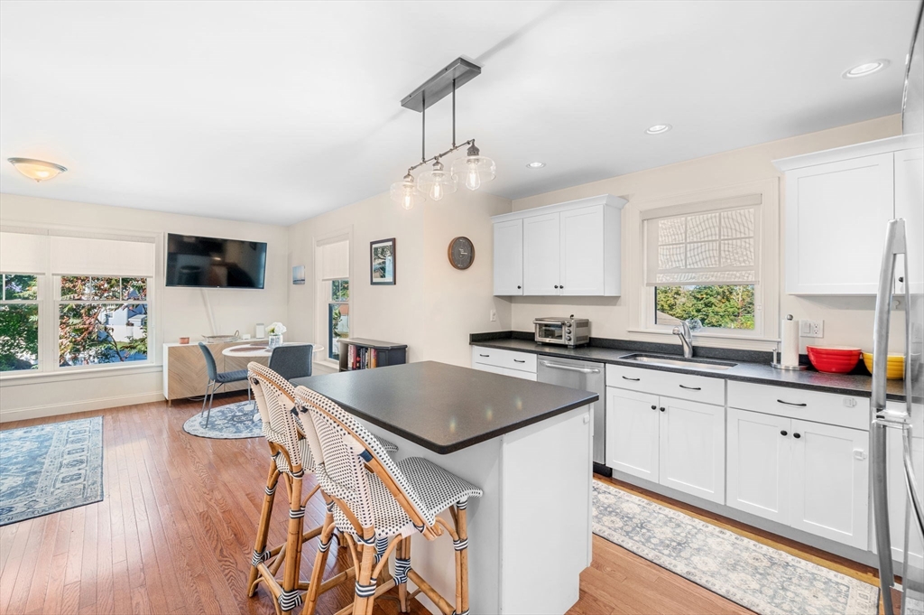 2-4 Gracie Lane, Unit 4 Swampscott, MA 01907 - Photo 14 of 37 a kitchen with stainless steel appliances granite countertop a sink stove and wooden floor