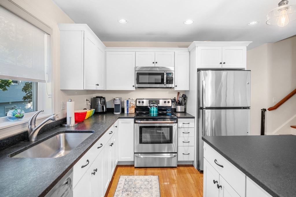 2-4 Gracie Lane, Unit 4 Swampscott, MA 01907 - Photo 15 of 37 a kitchen with stainless steel appliances granite countertop a sink stove and refrigerator