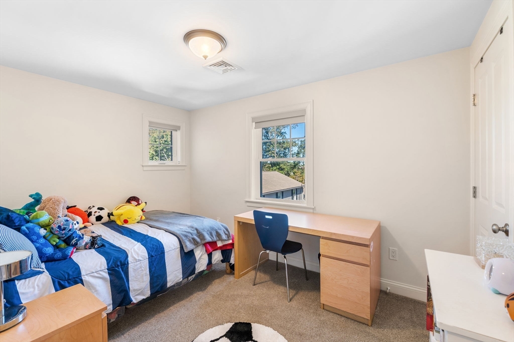 2-4 Gracie Lane, Unit 4 Swampscott, MA 01907 - Photo 26 of 37 a bedroom with a bed and a table