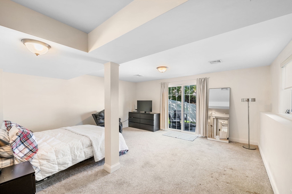 2-4 Gracie Lane, Unit 4 Swampscott, MA 01907 - Photo 29 of 37 a bedroom with a large bed and a large window