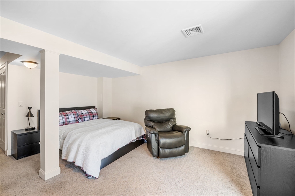 2-4 Gracie Lane, Unit 4 Swampscott, MA 01907 - Photo 30 of 37 a bedroom with a bed and a television