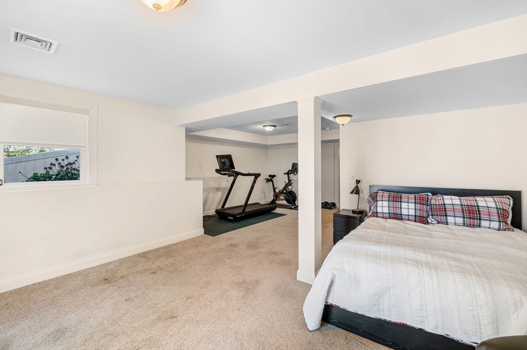 2-4 Gracie Lane, Unit 4 Swampscott, MA 01907 - Photo 31 of 37 a bed room with a bed and paintings on the wall