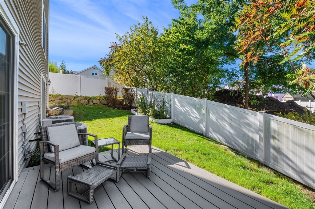 2-4 Gracie Lane, Unit 4 Swampscott, MA 01907 - Photo 36 of 37 a view of chairs and table in patio with wooden fence
