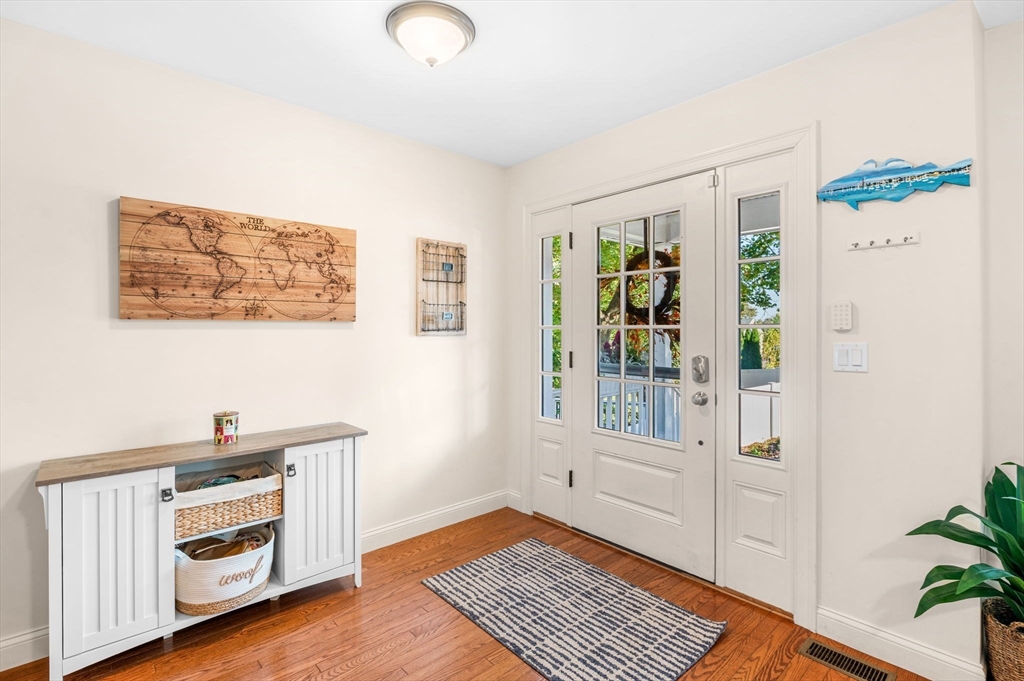 2-4 Gracie Lane, Unit 4 Swampscott, MA 01907 - Photo 7 of 37 a view of an empty room with a window and wooden floor