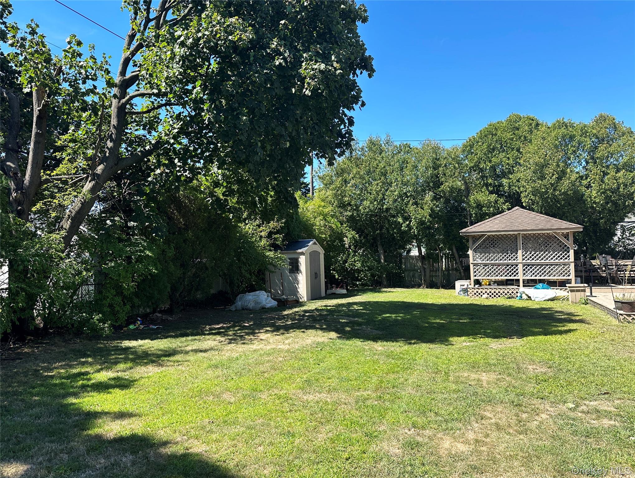 94 Mallard Road Levittown, NY 11756 - Photo 13 of 15 View of yard featuring a shed and a covered and enclosed pergola