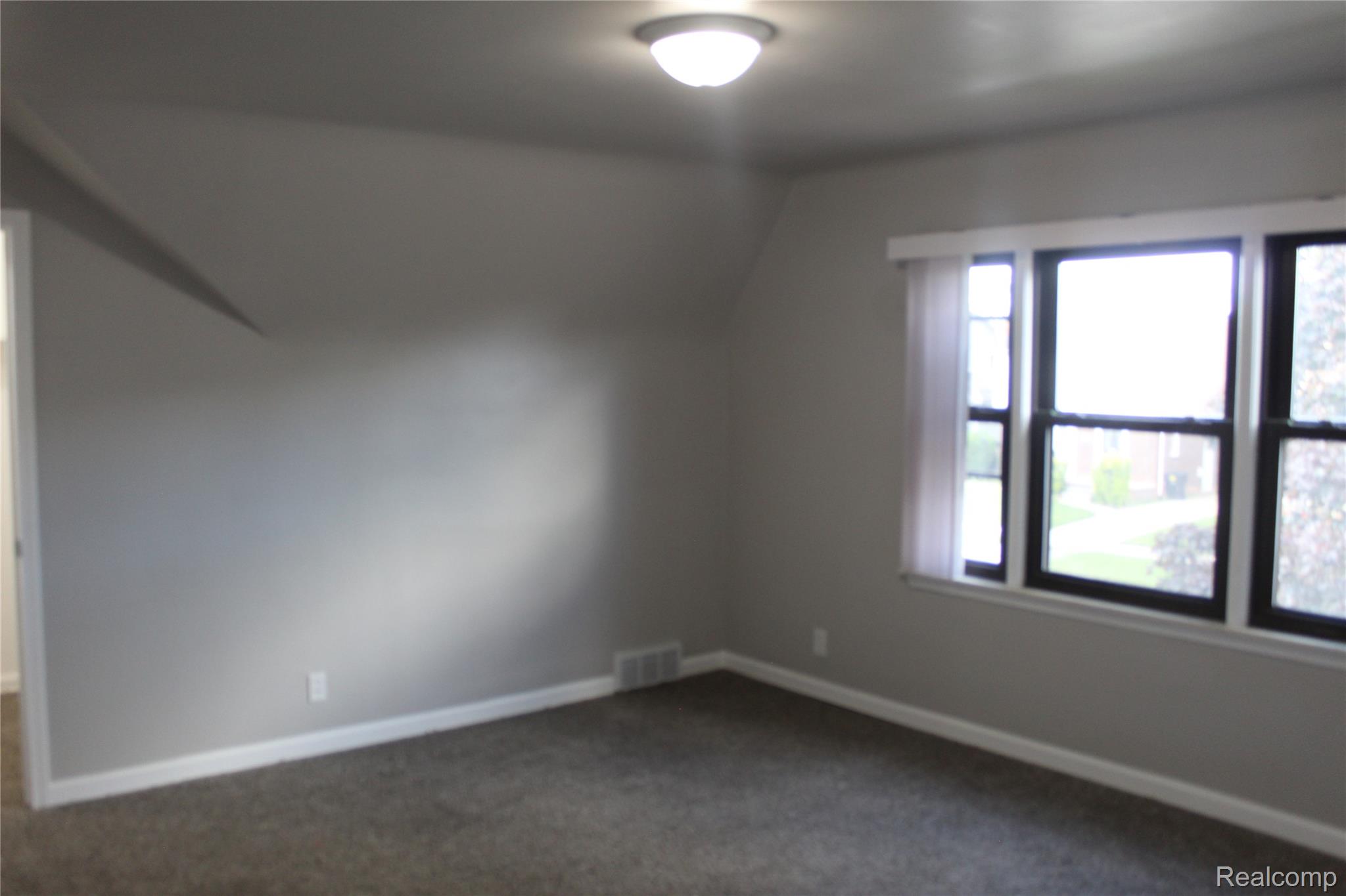 5543 Balfour Road Detroit, MI 48224 - Photo 46 of 54 Spacious room featuring neutral grey walls and dark carpeting