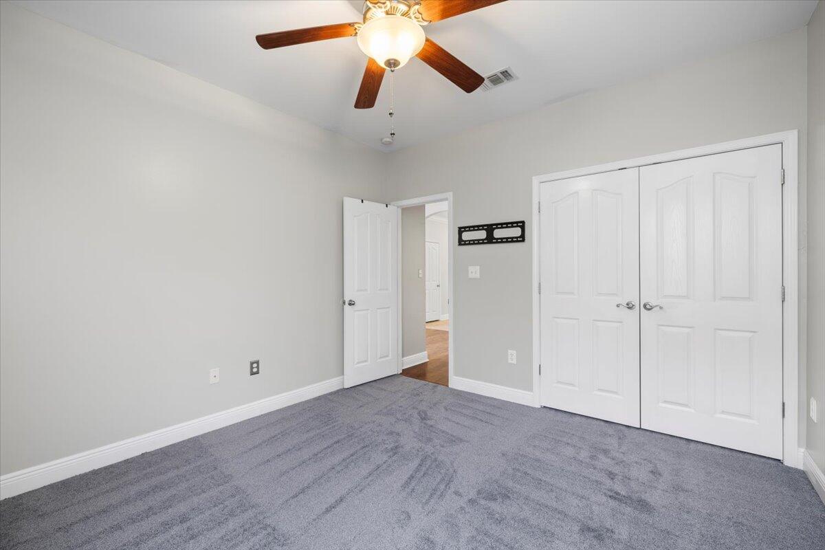 3629 Topaz Circle Navarre, FL 32566 - Photo 13 of 28 an empty room with closet and a ceiling fan