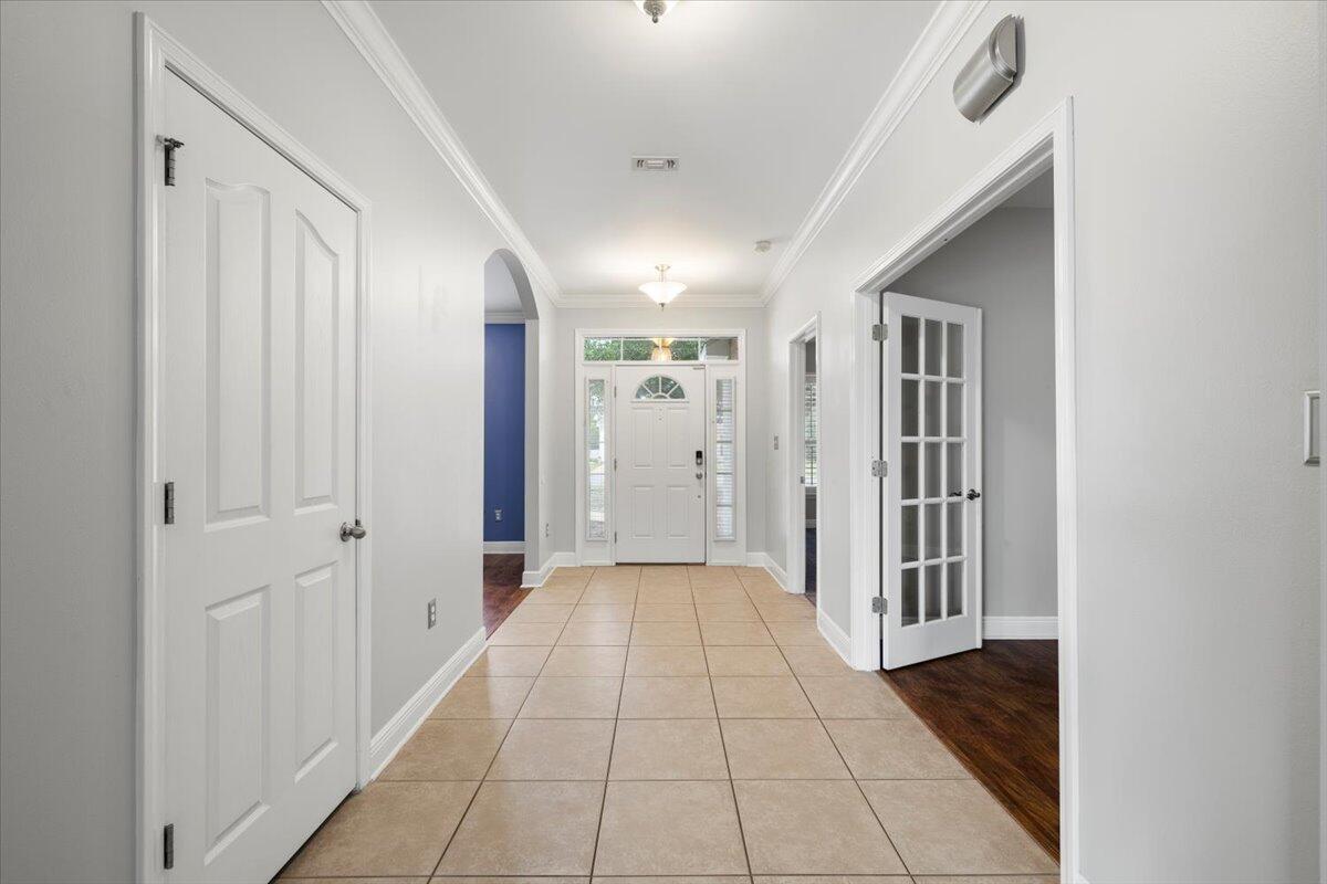 3629 Topaz Circle Navarre, FL 32566 - Photo 14 of 28 a view of a hallway with wooden floor and staircase