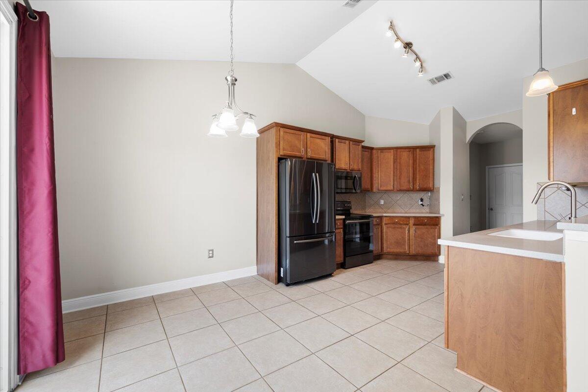 3629 Topaz Circle Navarre, FL 32566 - Photo 17 of 28 a kitchen with stainless steel appliances a refrigerator and a stove top oven