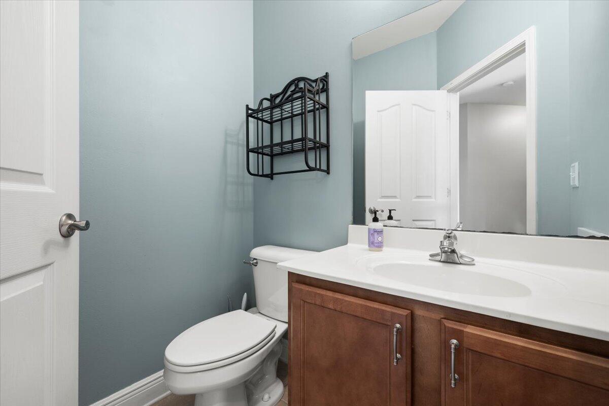 3629 Topaz Circle Navarre, FL 32566 - Photo 21 of 28 a bathroom with a sink vanity mirror and toilet