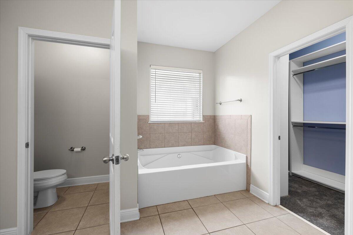 3629 Topaz Circle Navarre, FL 32566 - Photo 25 of 28 a bathroom with a bathtub and a toilet