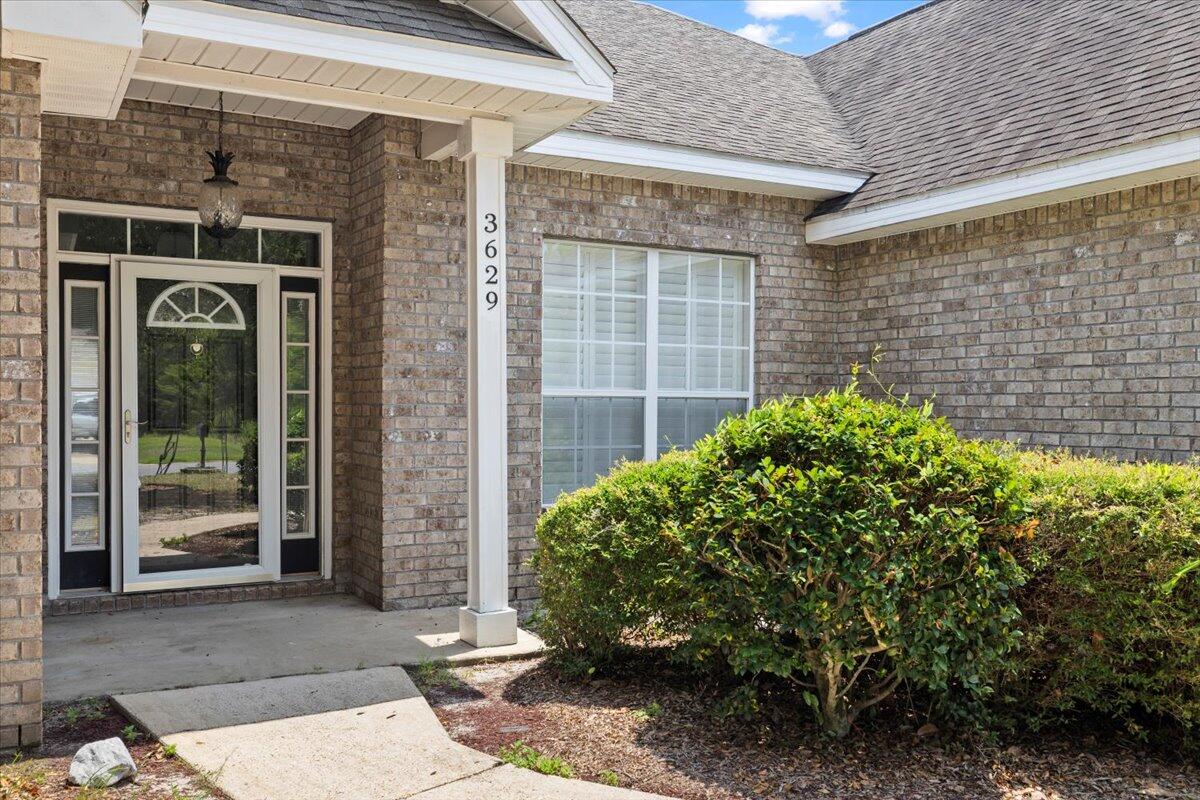 3629 Topaz Circle Navarre, FL 32566 - Photo 4 of 28 a view of a brick house with a large windows