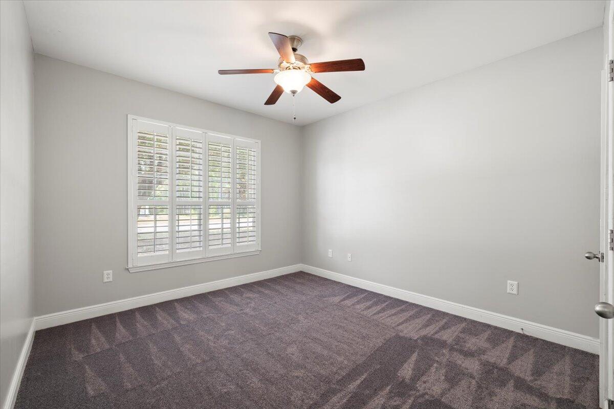 3629 Topaz Circle Navarre, FL 32566 - Photo 5 of 28 an empty room with ceiling fan and window