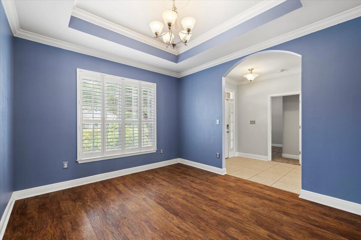 3629 Topaz Circle Navarre, FL 32566 - Photo 7 of 28 a view of an empty room with a window and wooden floor