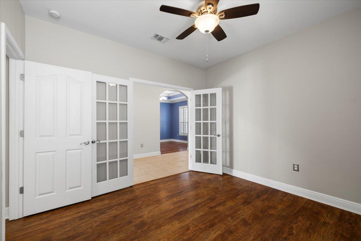 3629 Topaz Circle Navarre, FL 32566 - Photo 10 of 28 a view of an empty room with wooden floor and a window