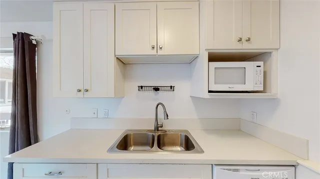 a kitchen with appliances a refrigerator and a stove