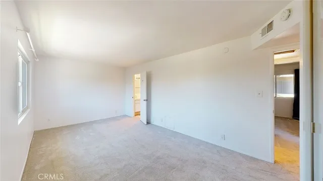 a bathroom with a sink vanity granite toilet and a mirror
