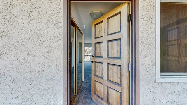 an empty room with closet and windows