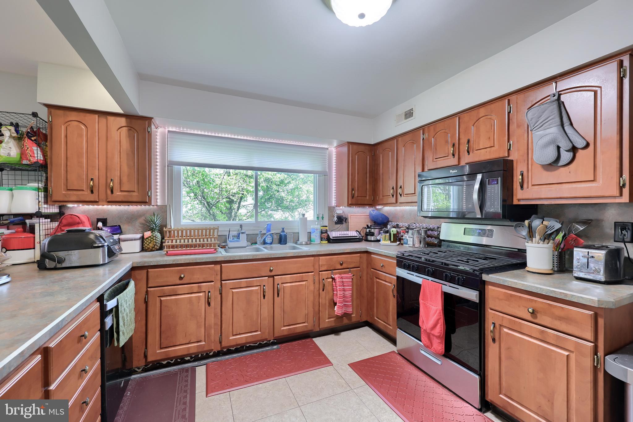 2188 Esbenshade Road York, PA 17408 - Photo 5 of 29 a kitchen with granite countertop a sink stove top oven and cabinets