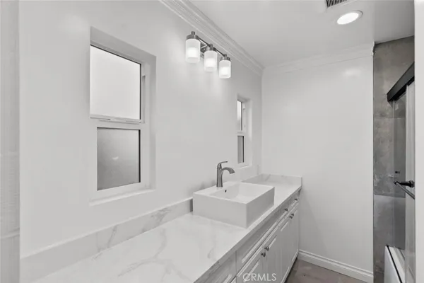 a bathroom with a sink and mirror with toilet