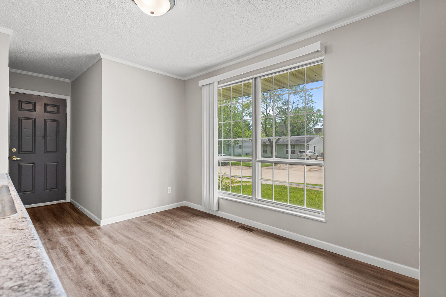 3214 York Drive Champaign, IL 61821 - Photo 14 of 27 a view of an empty room with wooden floor and a window