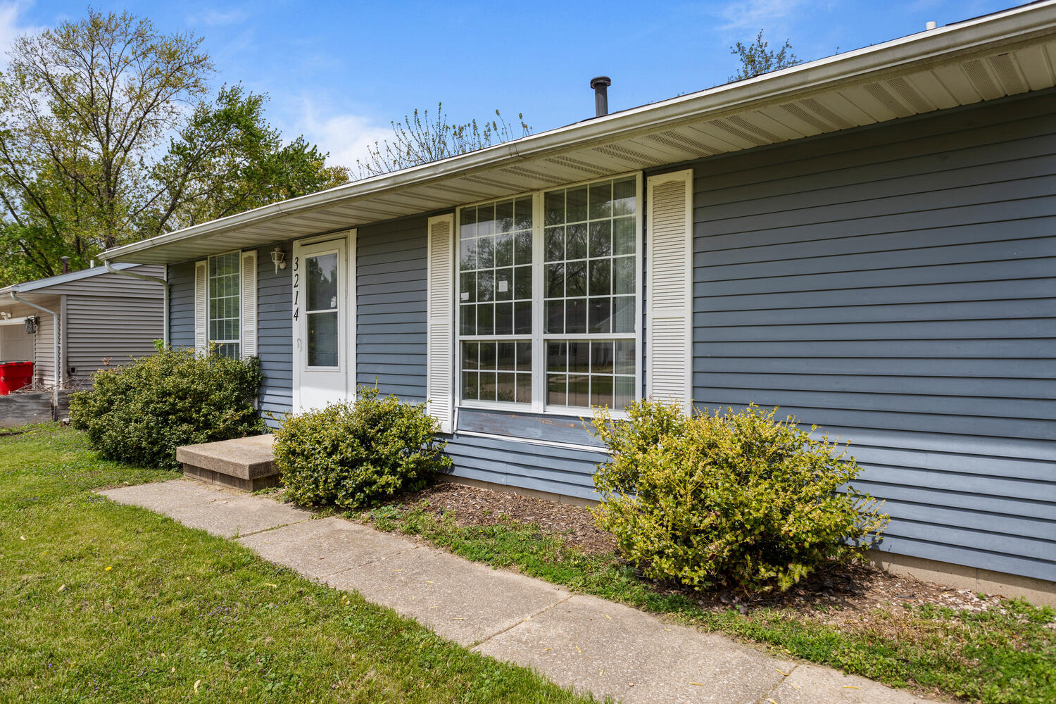 3214 York Drive Champaign, IL 61821 - Photo 3 of 27 a front view of a house with garden