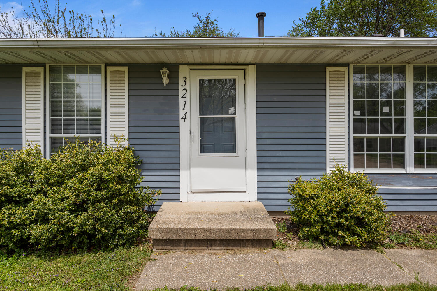 3214 York Drive Champaign, IL 61821 - Photo 4 of 27 a front view of a house with a garden