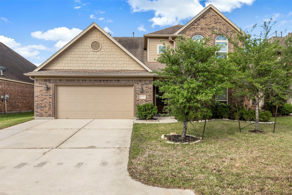 This home features a spacious exterior, lush landscaping, and an ample driveway.
