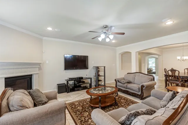 a living room with furniture a fireplace and a flat screen tv