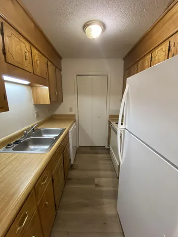 a kitchen with a sink and refrigerator