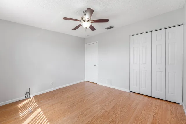 a view of a room with a ceiling fan