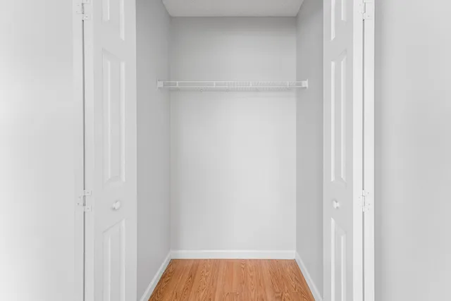 a view of a room with wooden floor