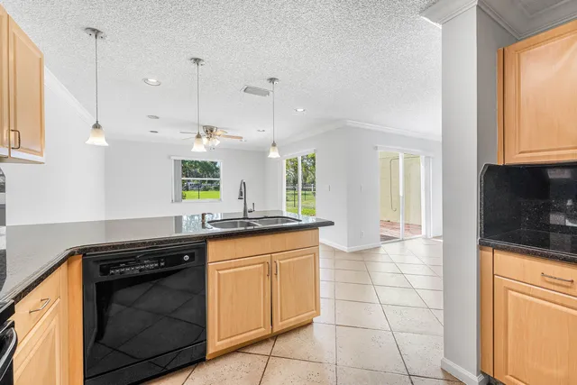 a kitchen with a sink a stove and cabinets