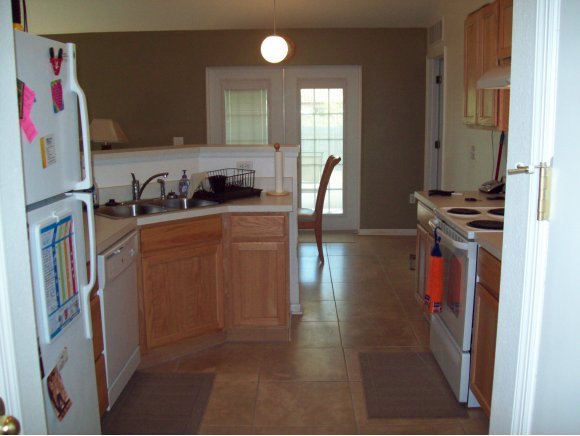 331 Southwest Santa Rosa Palm Bay, FL 32908 - Photo 5 of 10 a kitchen with stainless steel appliances granite countertop a refrigerator and a stove