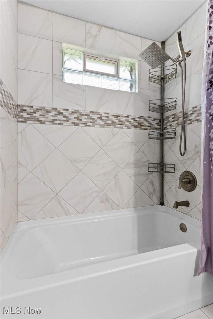 1824 Amherst Road Northeast Massillon, OH 44646 - Photo 16 of 34 Bathroom featuring plenty of natural light and shower / bath combo with shower curtain