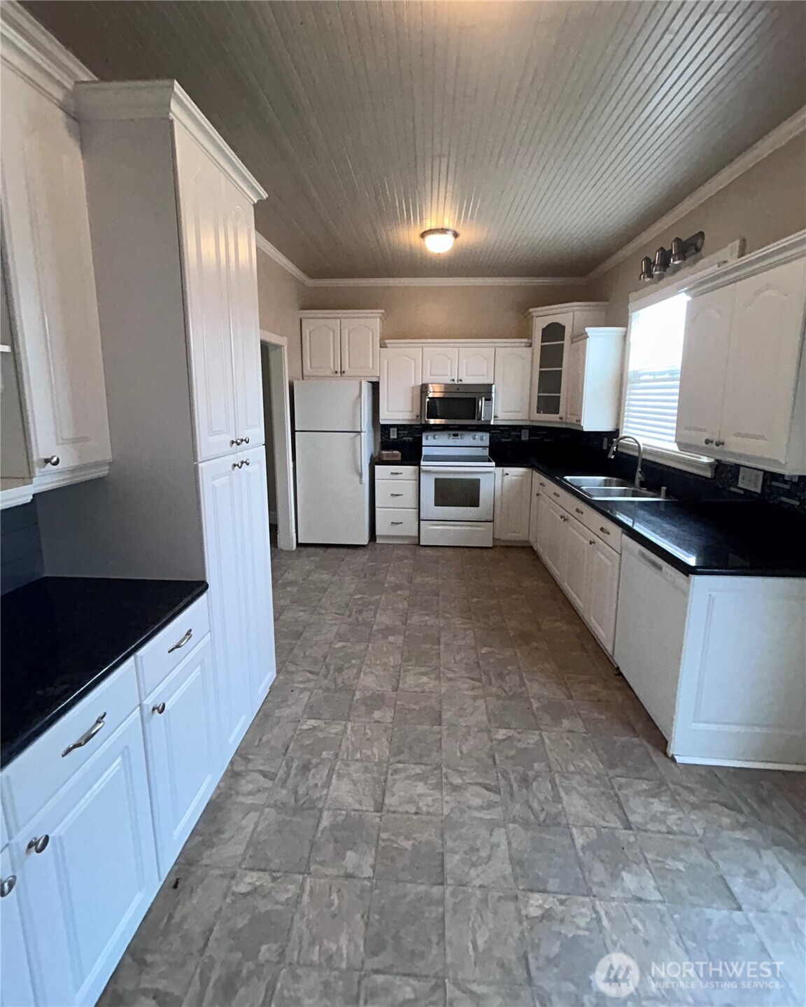 2716 South 14th Street Tacoma, WA 98405 - Photo 12 of 28 a large kitchen with cabinets and stainless steel appliances