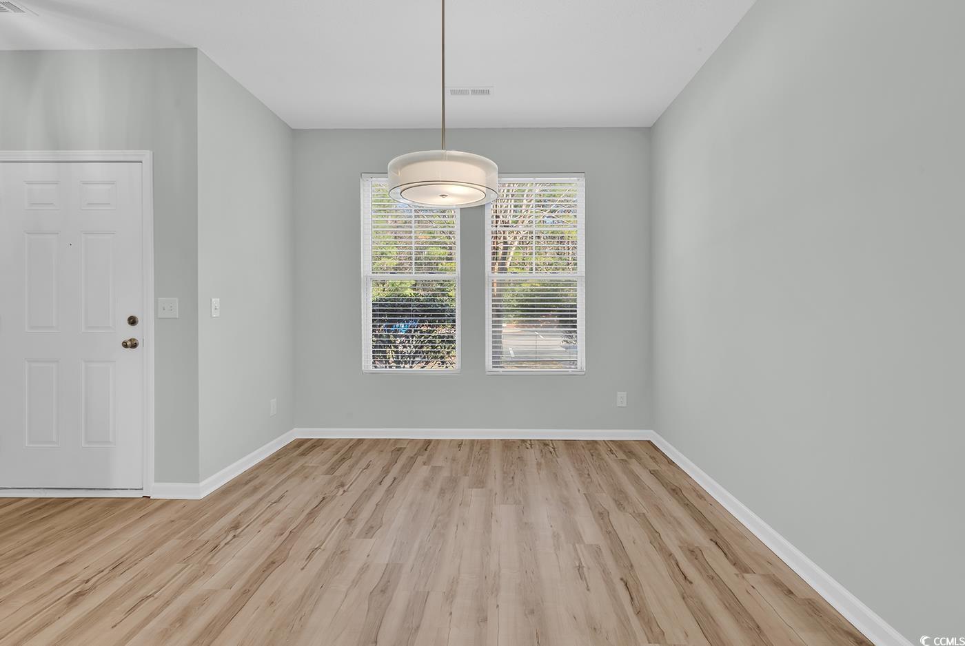 308 Kiskadee Loop, Unit E Conway, SC 29526 - Photo 5 of 36 Unfurnished dining area with light wood-type flooring and baseboards