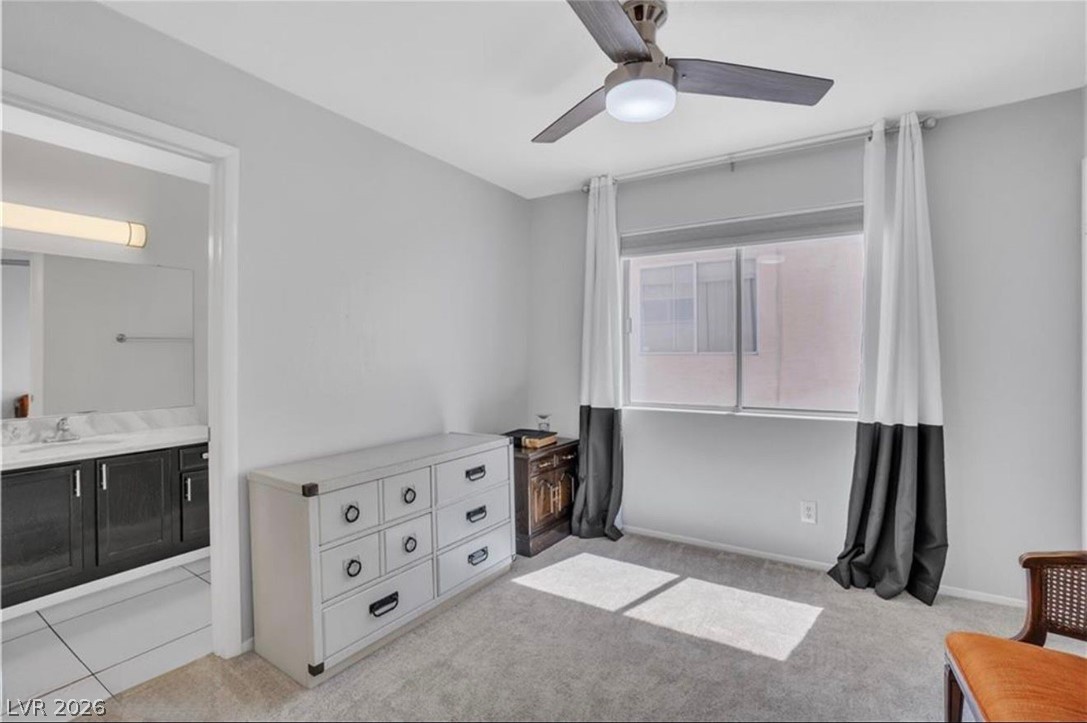 6429 Winding Ridge Las Vegas, NV 89156 - Photo 11 of 22 An inviting room features a functional ceiling fan, plush carpet, and a naturally illuminated window.