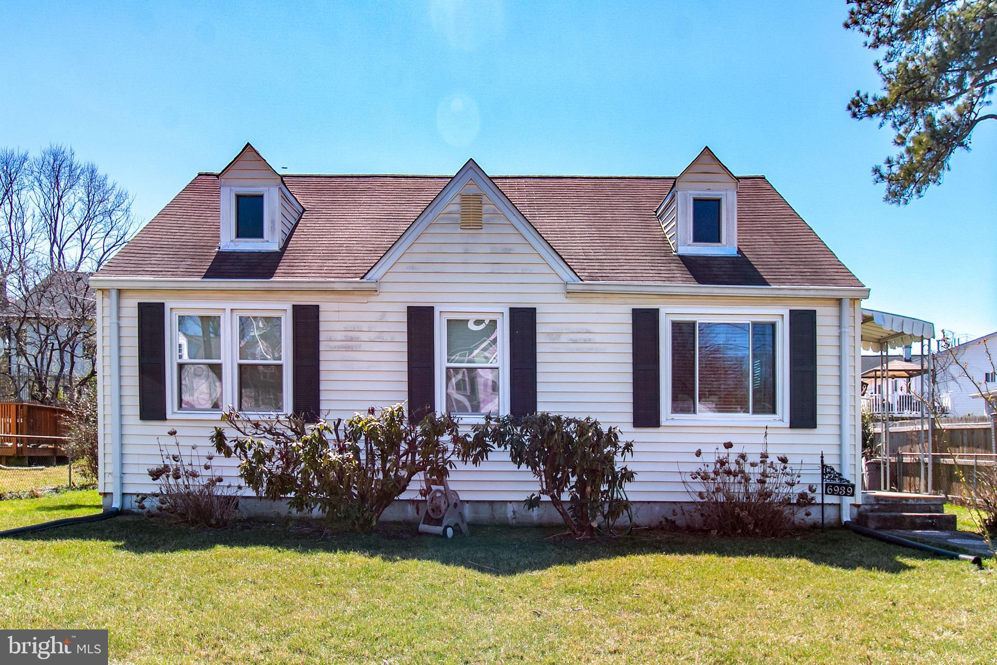 a front view of a house with a garden and plants