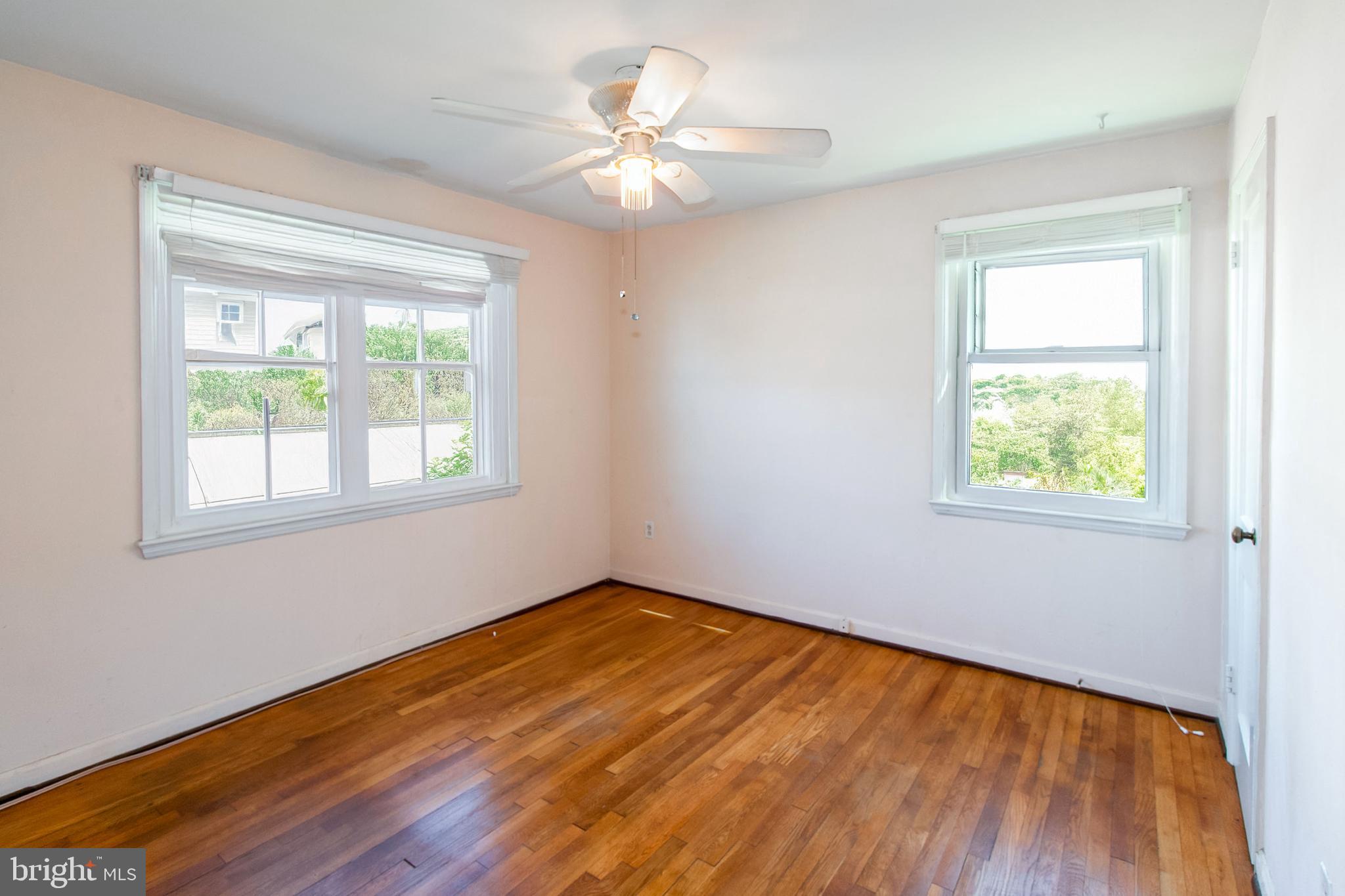 6939 Weston Road Falls Church, VA 22042 - Photo 16 of 25 a view of an empty room with wooden floor and a window