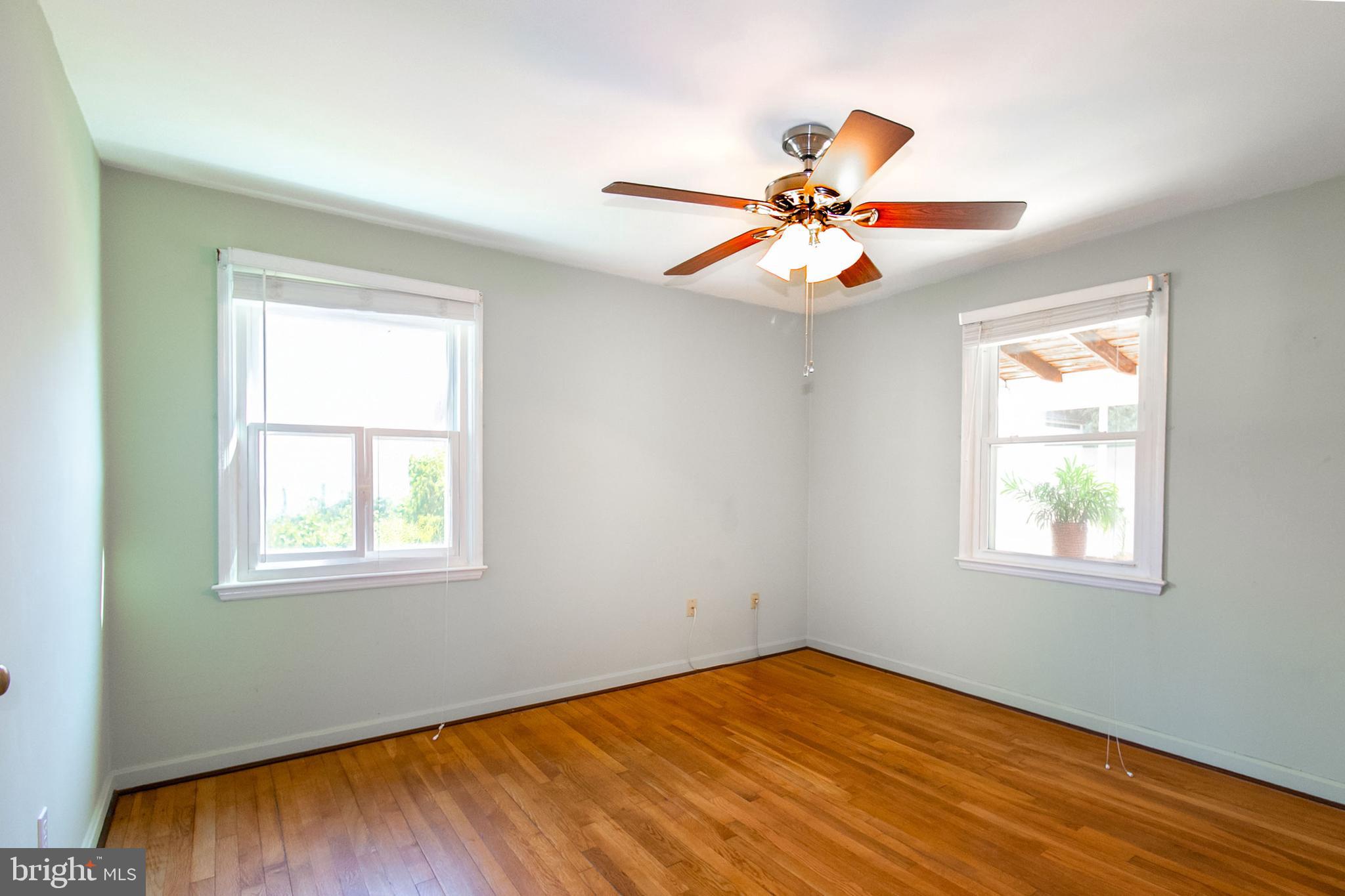 6939 Weston Road Falls Church, VA 22042 - Photo 17 of 25 a view of an empty room with window and wooden floor