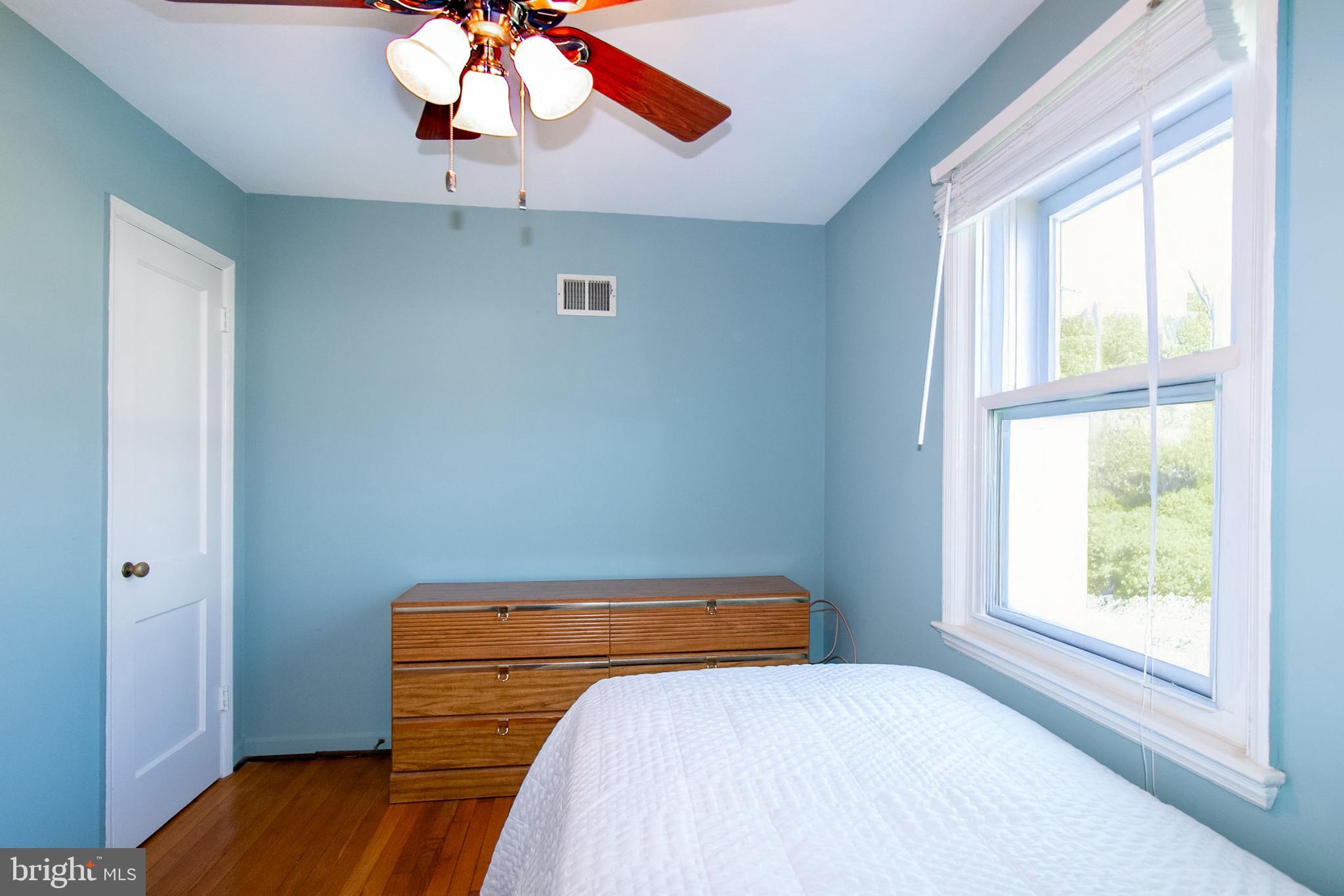 6939 Weston Road Falls Church, VA 22042 - Photo 19 of 25 a bedroom with a bed and a chandelier